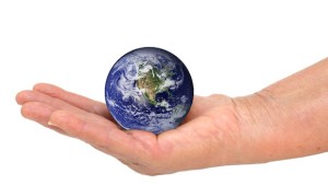 Small globe world earth in the palm of someone's hand