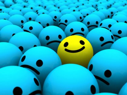 A single smiling yellow happy face amidst many sad blue faces