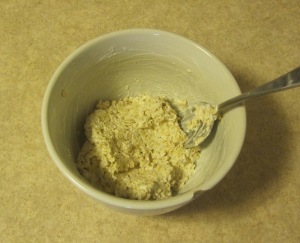 Raw oats mixed with yogurt in a white bowl