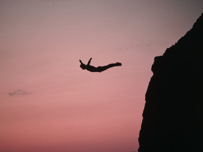 Person diving off of a cliff