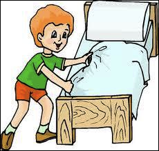 A disciplined young boy makes his bed in the morning