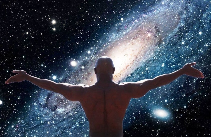 Muscular bald man opening his arms to the universe to signify the unification between spirituality and self improvement