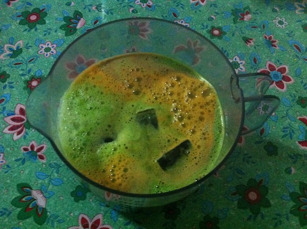 A green juice with ice cubes in it