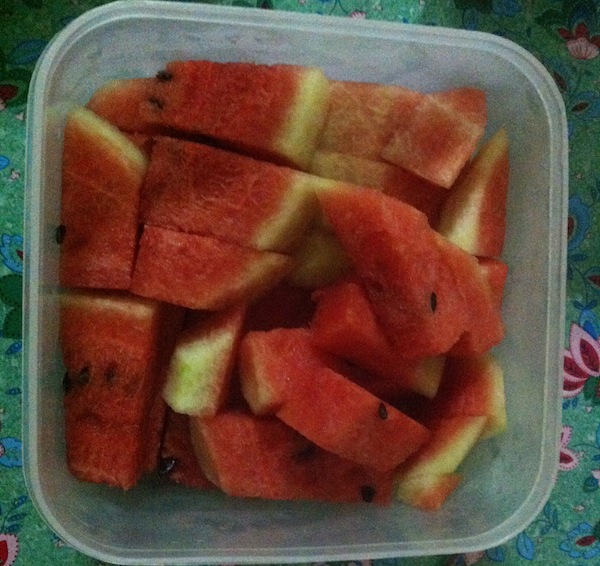 Watermelon cut into chunks in a plastic container