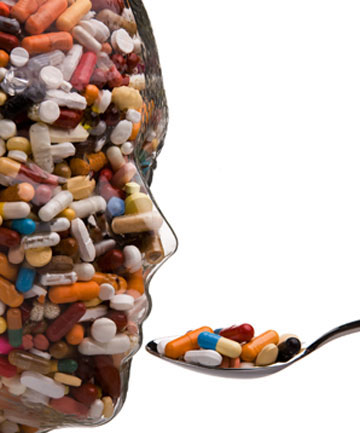 A man made of pills being fed a spoonful of pills