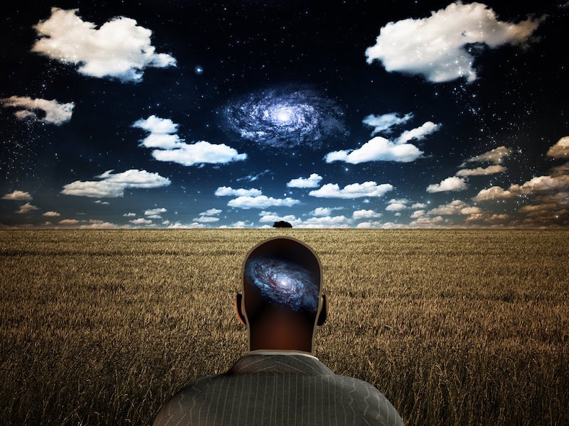 Man looking at the galaxy with the galaxy in his mind to represent cosmological confirmation bias