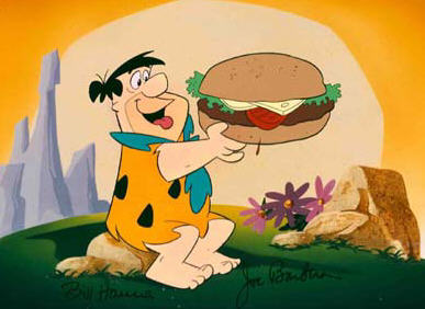 Fred Flintstone eating a giant hamburger
