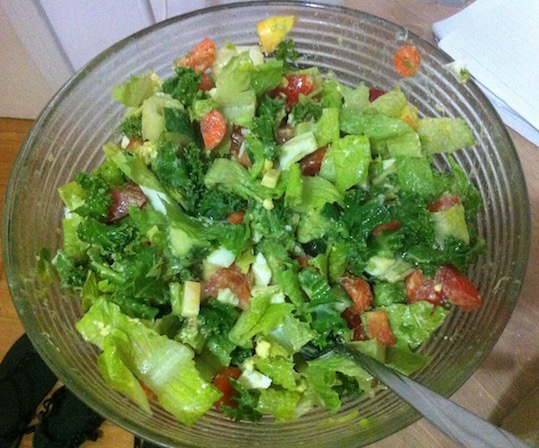 Salad with lettuce, tomato, kale, boiled eggs, olive oil, carrots, cheese, and more