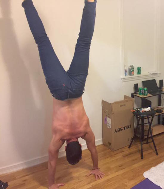 Aaron practicing handstands against the wall