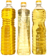 Three bottles of vegetable oil on a white background