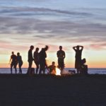How to make friends in a new city - group of friends on the beach at sunset